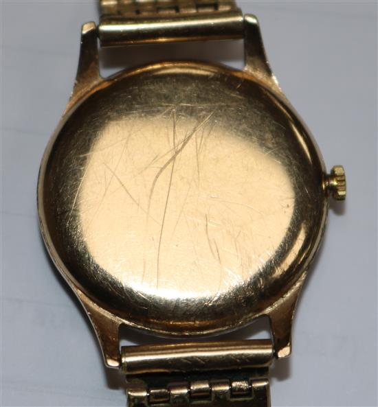 A gentlemans 1940s 9ct gold Omega wrist manual wind watch, with black Arabic dial on rolled gold bracelet.
